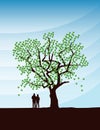 couple in love stands under a big tree at sunset Royalty Free Stock Photo
