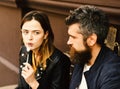 Couple in love takes a bite during break. Woman and man with surprised faces have date at cafe. Royalty Free Stock Photo