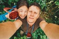 Couple in love taking self-portrait in summer raspberry garden