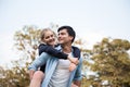 Couple in love. Boyfriend carrying his girlfriend on piggyback Royalty Free Stock Photo