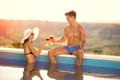 Couple in love toasting with cocktail in pool Royalty Free Stock Photo