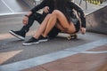 Couple in love together sits on a skateboard in a skate park at the summertime Royalty Free Stock Photo