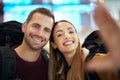 Couple, love and travel selfie at airport lobby taking pictures for holiday, vacation or global traveling. Portrait