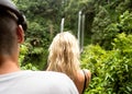 Couple in love travels to waterfalls in Indonesia, Bali, rear view