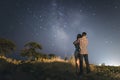 Couple in love under stars of Milky Way Galaxy