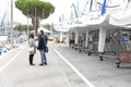 Couple in love walking along the promenade. Happy man and woman walking along the promenade along the sea - Immagine