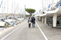 Couple in love walking along the promenade. Happy man and woman walking along the promenade along the sea - Immagine