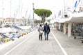 Couple in love walking along the promenade. Happy man and woman walking along the promenade along the sea - Immagine