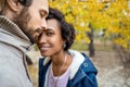 Couple in love are walking in the autumn park. Afroamerican girl with a European Royalty Free Stock Photo