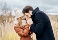 Couple in love walking in the autumn Park, cool fall weather. A man and a woman embrace and kiss, love and affection yellow autumn Royalty Free Stock Photo