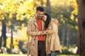 Couple in love walking on autumn park, enjoying a beautiful autumn day Royalty Free Stock Photo