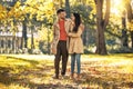 Couple in love walking on autumn park, enjoying a beautiful autumn day Royalty Free Stock Photo