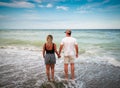 Couple in love walking on the beach holding hands. Royalty Free Stock Photo