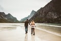 Couple in love walking holding hands on wild sea beach Royalty Free Stock Photo