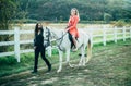 Couple in love walking with horse on countryside. Romantic love story of sensual couple. Woman riding grey arabian horse Royalty Free Stock Photo