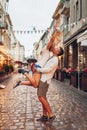 Couple in love walking in old Lviv city wearing traditional ukrainian shirts. Man raising woman having fun outdoors Royalty Free Stock Photo