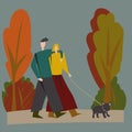 A couple in love walks in the park with their beloved dog. A man hugs a woman. The concept of love and family values. Autumn colou