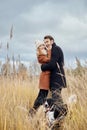 Couple in love on a warm autumn day walks in the Park with a cheerful dog Spaniel. Love and tenderness between a man and a woman Royalty Free Stock Photo