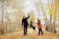 Couple in love on a warm autumn day walks in the Park with a cheerful dog Spaniel. Love and tenderness between a man and a woman Royalty Free Stock Photo