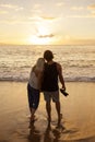 Couple in love watching a sunset at the beach together Royalty Free Stock Photo