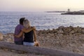 Couple in love watching sunset together on beach Royalty Free Stock Photo