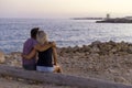 Couple in love watching sunset together on beach travel summer holidays Royalty Free Stock Photo