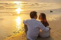 Couple in love watching sunset together on the beach travel summer holidays. People romance concept Royalty Free Stock Photo