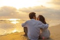 Couple in love watching sunset together on the beach travel summer holidays. People romance concept Royalty Free Stock Photo