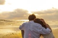 Couple in love watching sunset together on the beach travel summer holidays. People romance concept Royalty Free Stock Photo