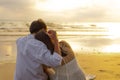 Couple in love watching sunset together on the beach travel summer holidays. People romance concept Royalty Free Stock Photo