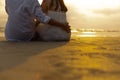 Couple in love watching sunset together on the beach travel summer holidays. People romance concept Royalty Free Stock Photo