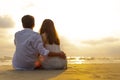 Couple in love watching sunset together on the beach travel summer holidays. People romance concept Royalty Free Stock Photo