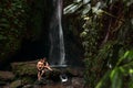 A couple in love on a waterfall. Honeymoon trip. Happy couple on the island of Bali. Beautiful couple travels the world. Royalty Free Stock Photo