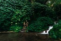 A couple in love at a waterfall in Indonesia. A couple in love in the tropics. Beautiful couple traveling on the island of Bali. Royalty Free Stock Photo