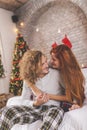 Couple wearing pajamas hugging on Christmas morning Royalty Free Stock Photo