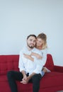 Couple in love woman hugging man on red sofa at home,Loving everything together,Happy and smiling Royalty Free Stock Photo