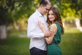 Couple in love: young girl and balding man in the garden