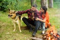 Couple in love, young happy family spend leisure with dog. Royalty Free Stock Photo