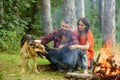 Couple in love, young happy family spend leisure with dog. Royalty Free Stock Photo