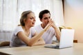 Couple lover talking and waving hand in a video conference on line with a laptop for contact friendship at home.