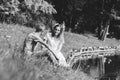 A happy young couple, a guy and a girl sitting on the grass near a river or lake Royalty Free Stock Photo