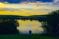 A couple of lovers on the lake at sunset