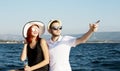 Beautiful couple of lovers sailing on a boat. Two fashion models posing on a sailing boat at sunset Royalty Free Stock Photo