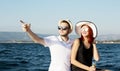 Beautiful couple of lovers sailing on a boat. Two fashion models posing on a sailing boat at sunset Royalty Free Stock Photo