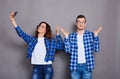 A couple of lovers takes a selfie on a gray background Royalty Free Stock Photo