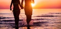 Couple of lovers walking inside water on tropical beach in summer vacation at sunset - Young people enjpying holidays - Love, Royalty Free Stock Photo