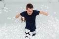 Couple of loving friends have fun surrounded by white plastic balls in a dry swimming pool. Royalty Free Stock Photo