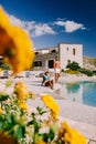 Couple on luxury vacation relaxing by the pool at an Agriturismo in Sicily Italy