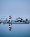 Couple on luxury vacation in Thailand, men and woman infinity pool looking out over the ocean Royalty Free Stock Photo