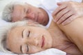 Couple lying in bed together sleeping Royalty Free Stock Photo